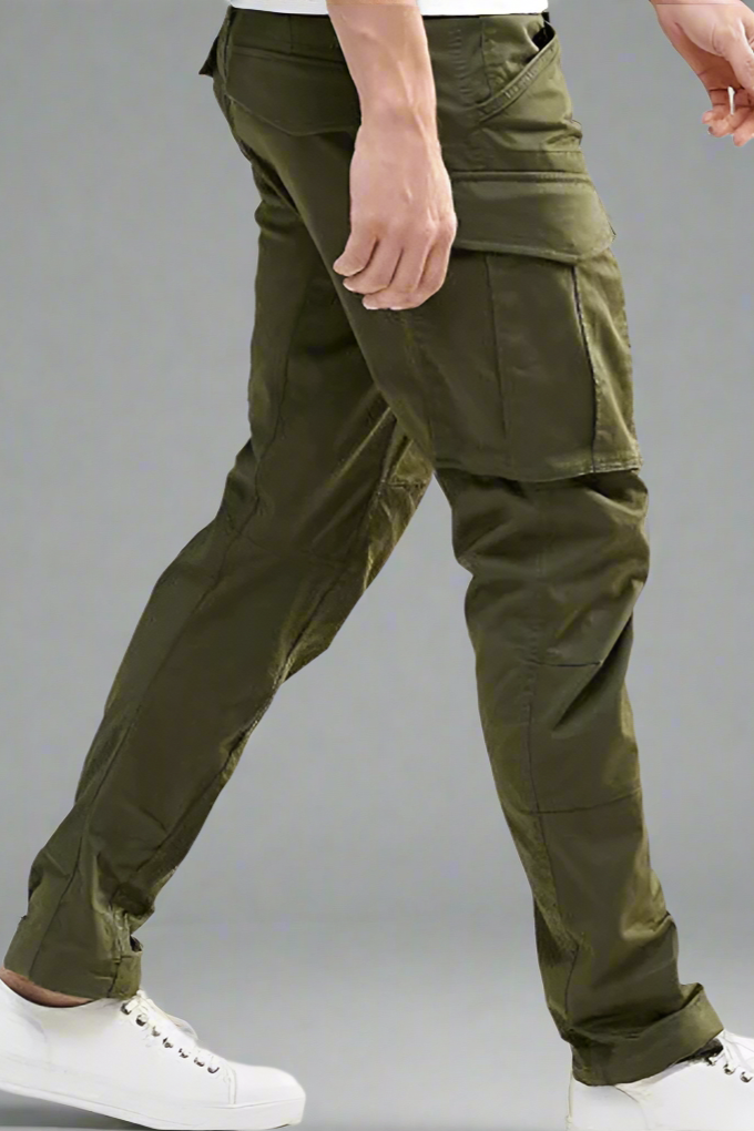 Green cargo pants worn by a person on a white background