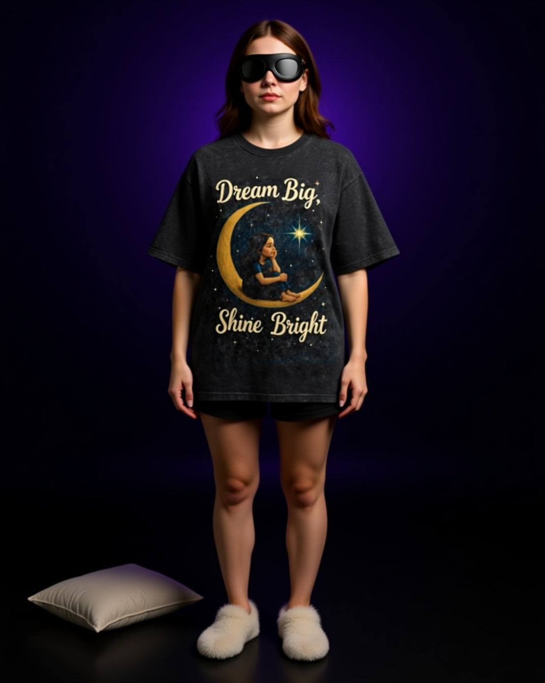 Person wearing a black t-shirt with 'Dream Big, Shine Bright' design on a dark background