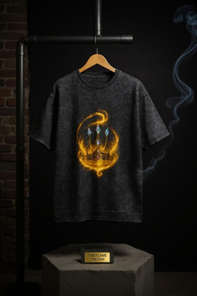 Black t-shirt with a gold and orange graphic design on a wooden hanger against a dark background.