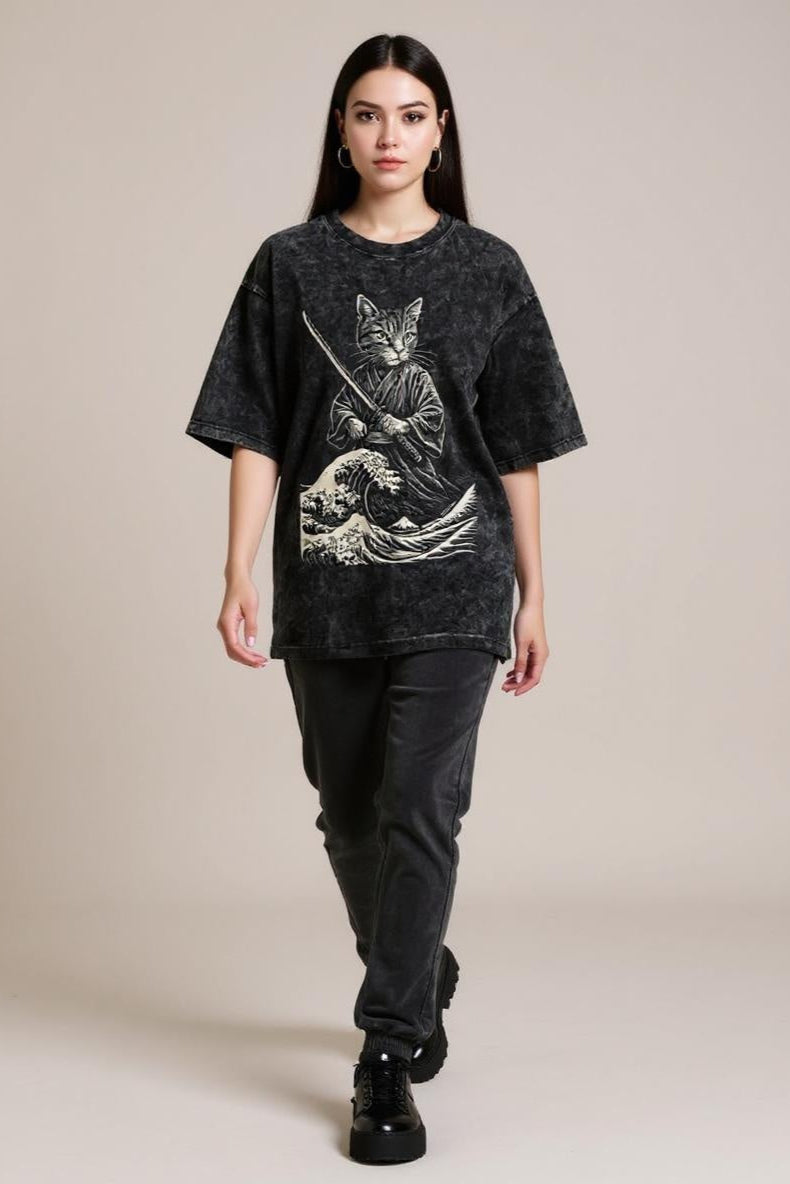Person wearing a black t-shirt with a graphic design on a beige background